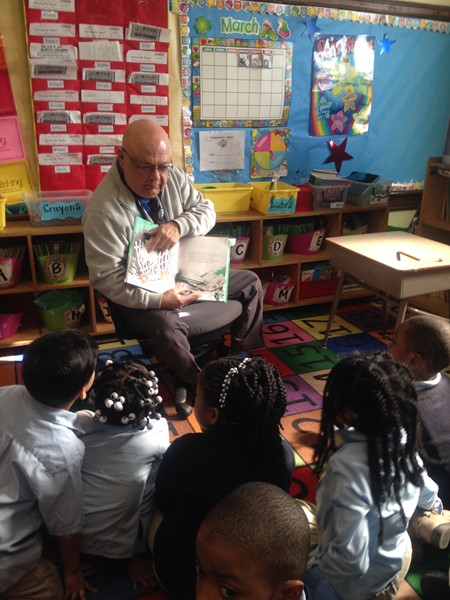 Luis Santiago, Business Administrator at DLEACS reads to first grade students.
